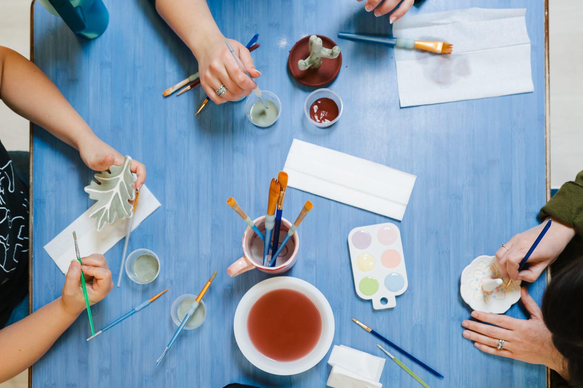 Overhead shot of colorful pottery being painted