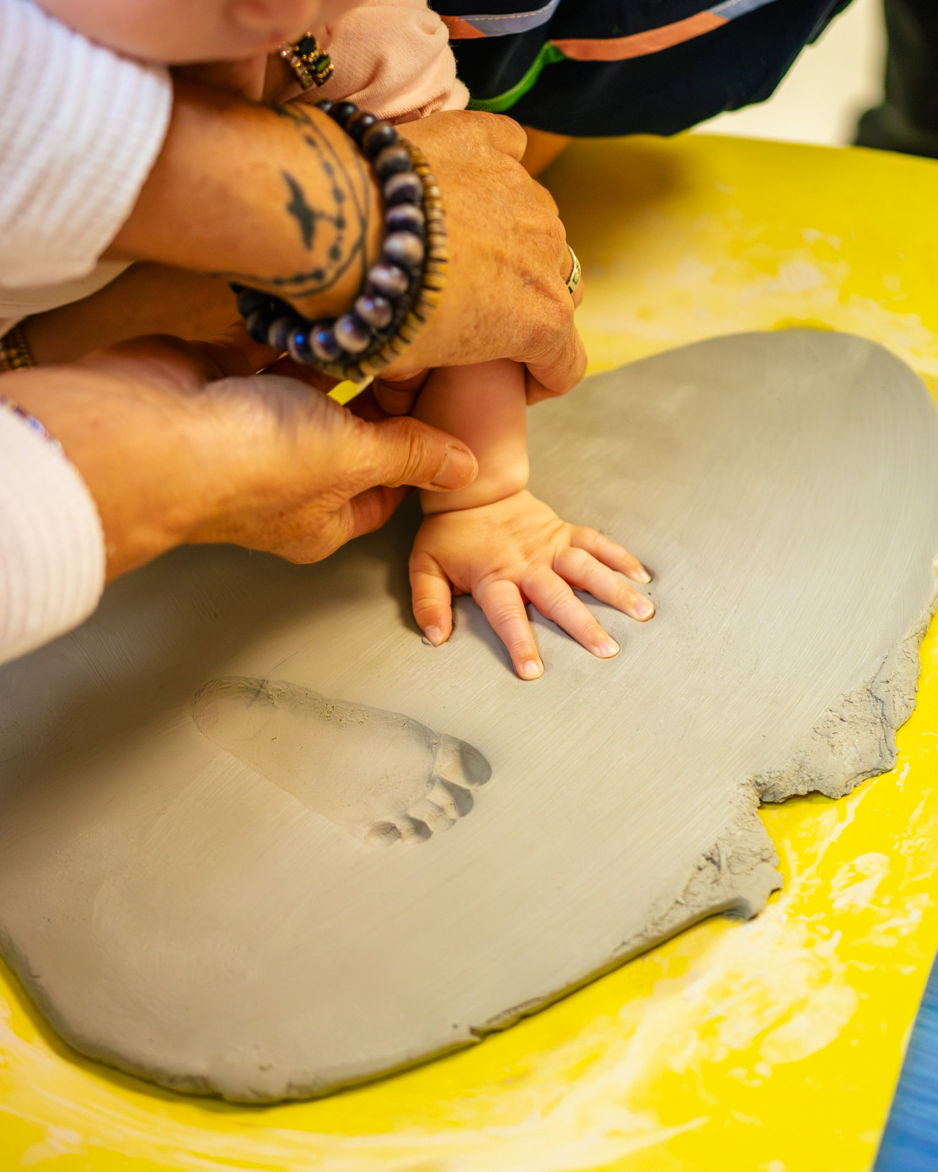 Friends painting pottery together and laughing