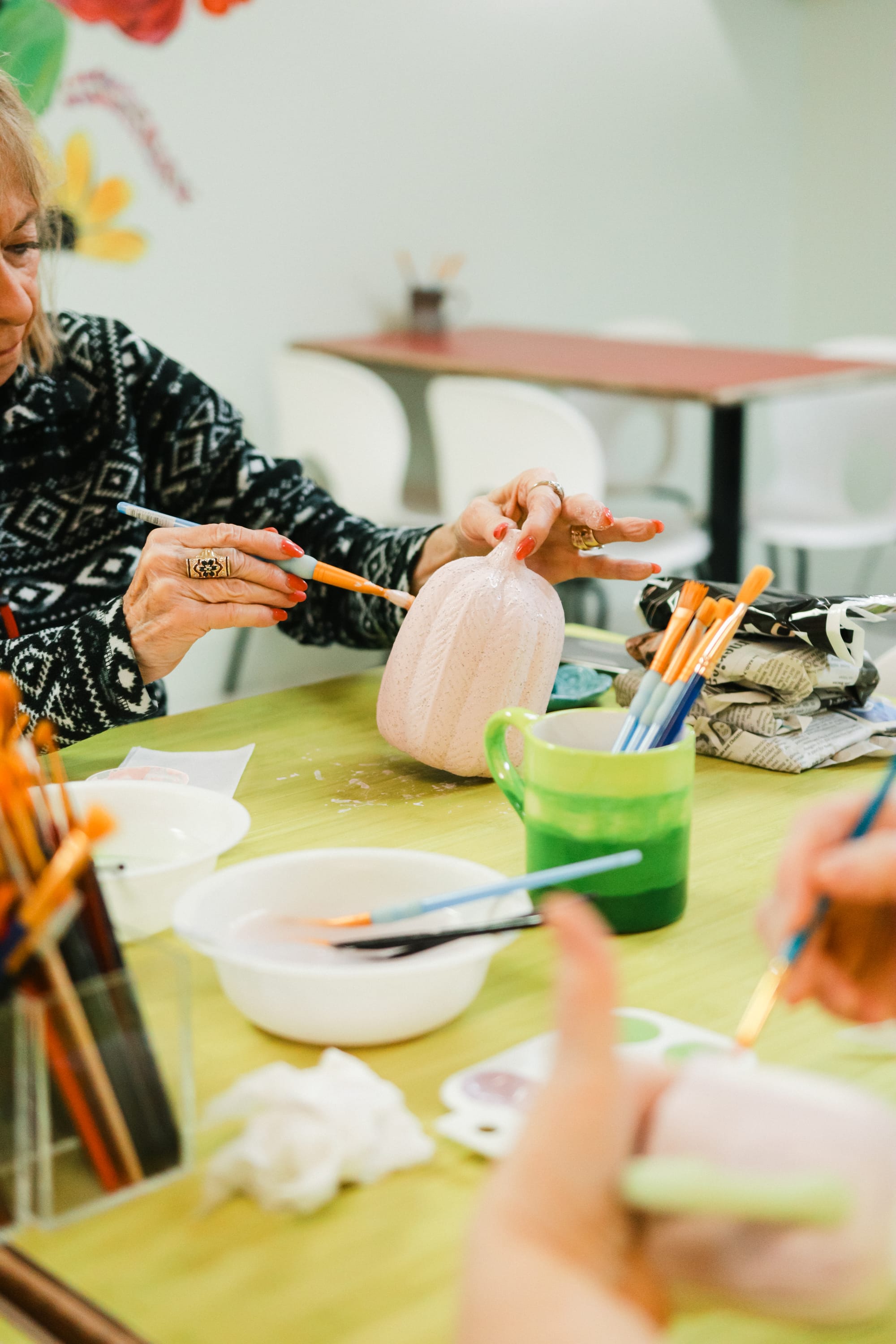 Ladies painting pottery together at the studio